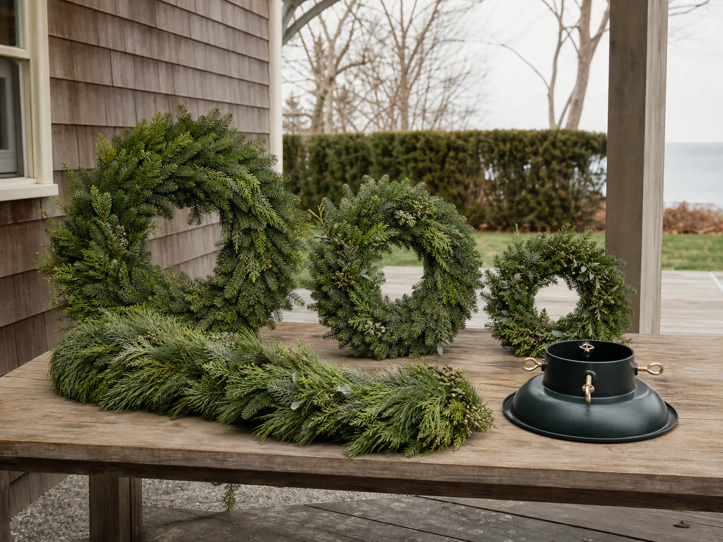 Representative loose garland, wreaths, and tree stand base prepared outside for delivery
